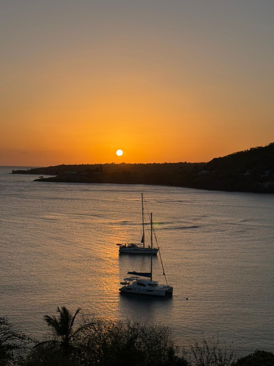 Sailboats at anchor off Laborie as the sun sets