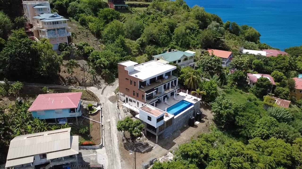 Aerial view of Palms La Batterie with the road and the sea beyond