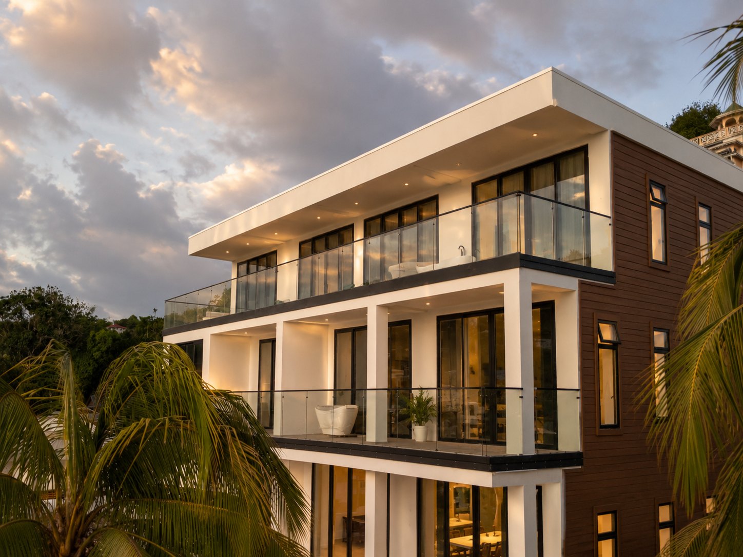 Palms La Batterie building exterior at sunset, with balconies on every level