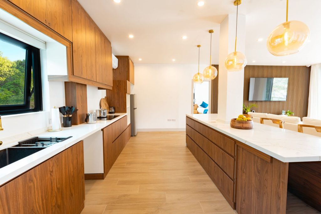 Penthouse chef's kitchen with walnut cabinets and a long marble island