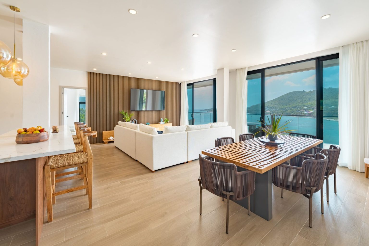 Penthouse dining table and lounge with the Caribbean Sea beyond