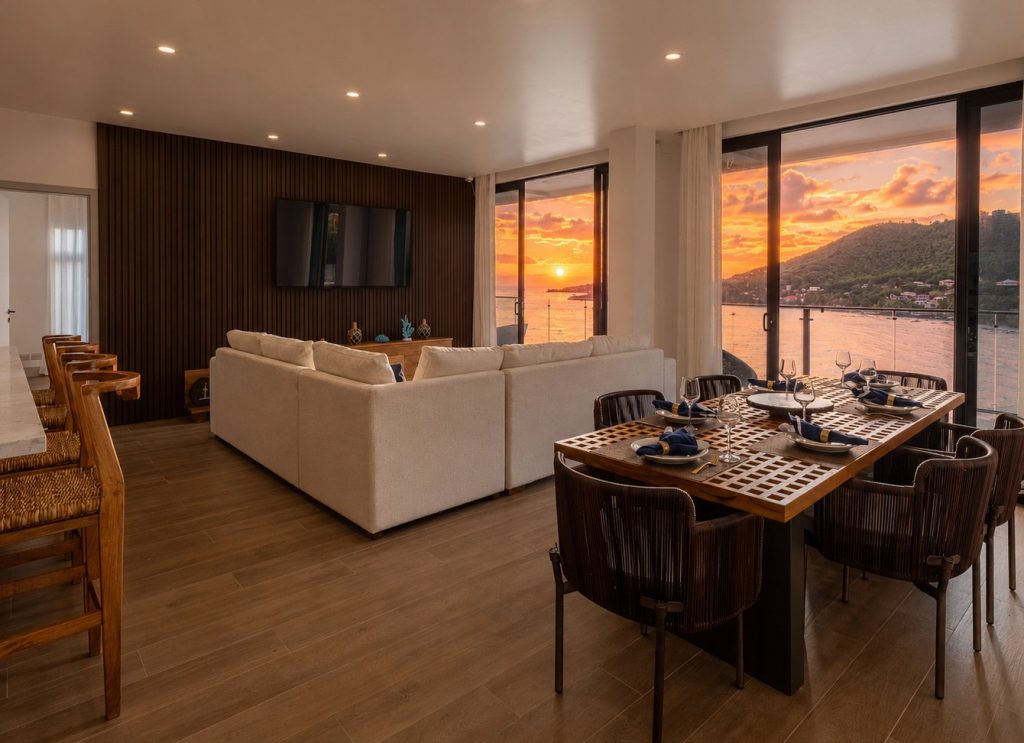 Penthouse living and dining room at sunset, looking out over Laborie Bay