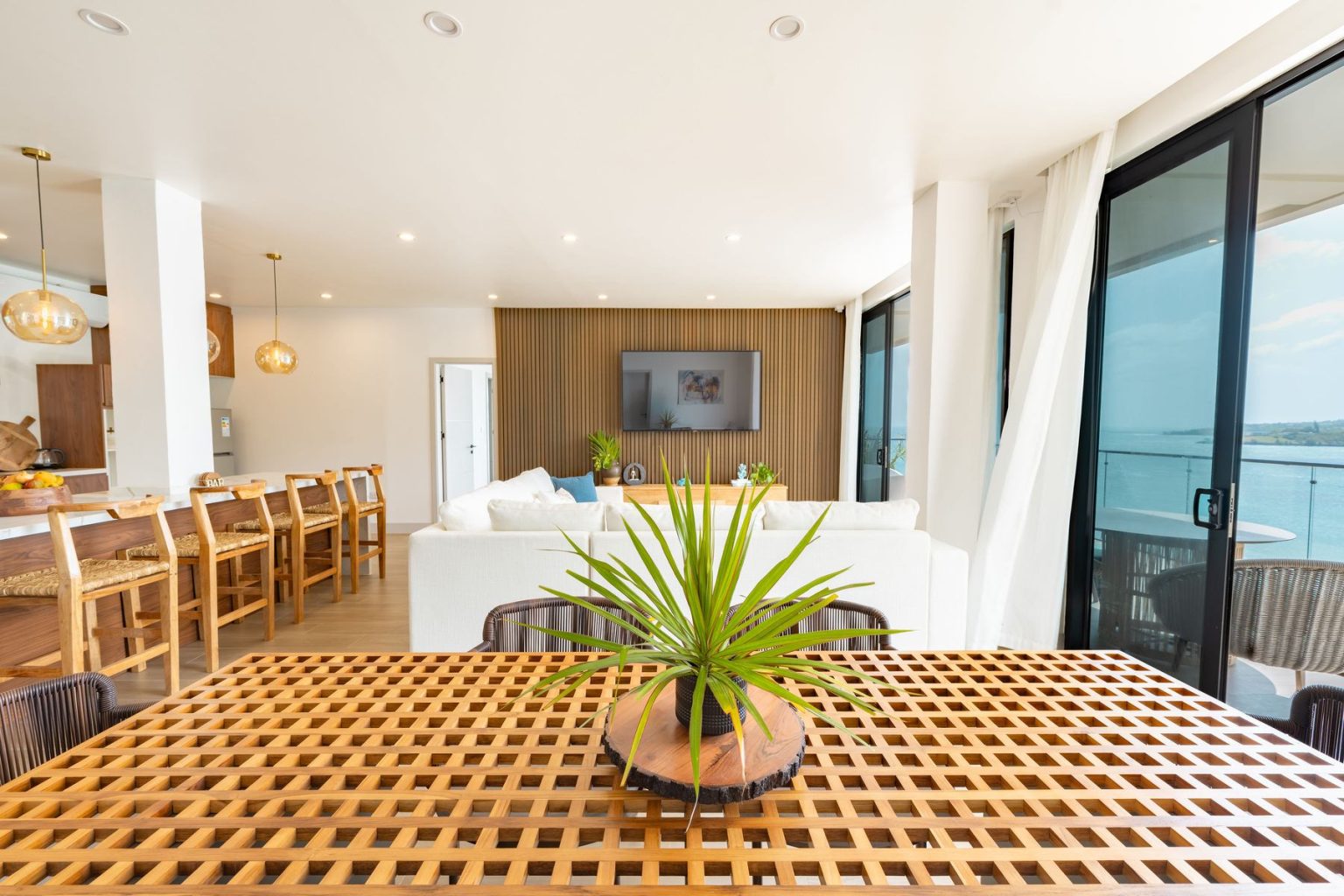 Teak dining table with a palm centrepiece in the Penthouse