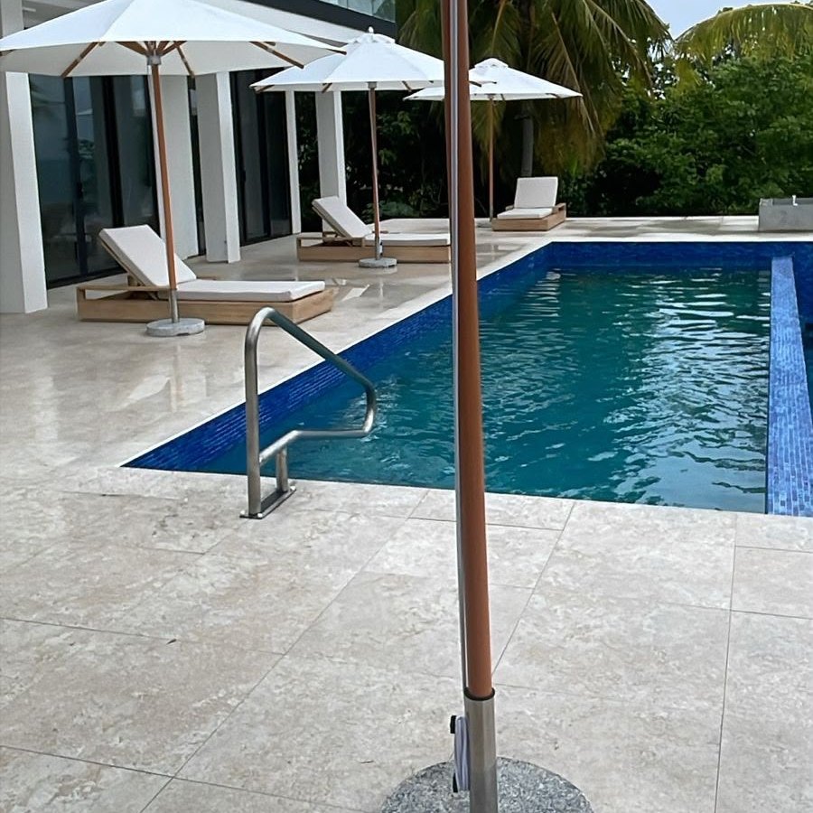 Parasol on the pool deck beside the infinity pool steps